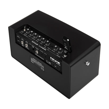 NU-X Mighty Space wireless modelling amp in matte black, rear angle showing control knobs, jacks, wireless receiver and rear panel on a white background.