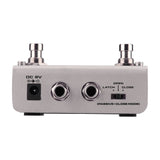 Rear view of the NU-X NMP-2 Dual Foot Controller Switch Pedal showing DC 9V input, two 6.35mm jacks and a latch/open/close mode switch.