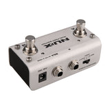 NU-X NMP-2 dual footswitch pedal in silver housing with two switches, LED indicators, dual jack inputs, latch mode toggle and 9V DC socket.