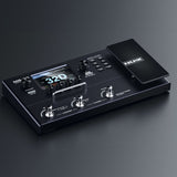NU-X MG-30 multi-effects modeller pedal in matte black with colour LCD, rotary encoders, footswitches and expression pedal, shown on a dark background.