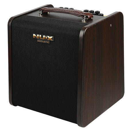 The NU-X Stageman II AC-80 Acoustic Amplifier boasts a sleek black front panel, complemented by wooden sides and topped with a brown leather handle. It includes Bluetooth audio streaming capabilities and convenient control knobs for easy access on the upper surface.