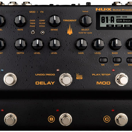 Close-up of the NU-X NME-5 Trident amp modeller and multi-FX pedal with black casing, orange labelling, control knobs, LCD screen and footswitches.