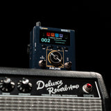 NU-X NSS-6 Solid Studio mkII amp and cab emulation pedal with colour display and data dial, shown on a Fender Deluxe Reverb amp against black.