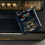 NU-X NSS-6 Solid Studio mkII amp and cab emulation pedal in dark blue with colour display showing Jazz Chorus 120 preset, resting on a guitar amp.