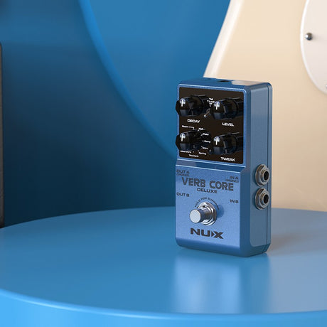 NU-X Verb Core Deluxe Stereo Reverb Pedal in blue with Decay, Level and Tweak knobs, footswitch and 6.35mm jacks, shown on a blue surface.