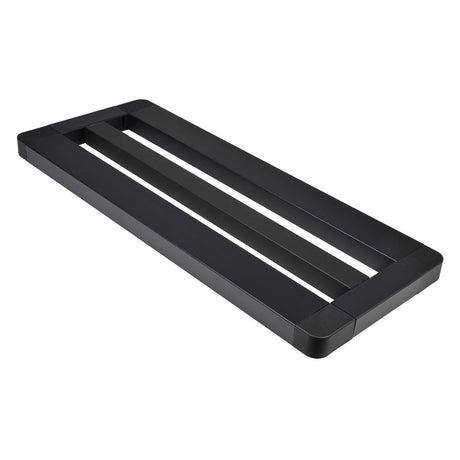 A black, rectangular metal frame described as the Chord Mini Pedal Board With Bag, featuring two open slots and a minimalist modern design. With non-slip feet and rounded corners, this board serves as a sturdy base or support, making it ideal for use as a table base or monitor stand.