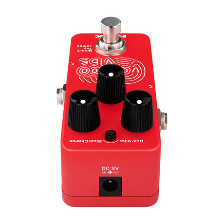 Side view of the NU-X NCH-3 Voodoo Vibe Mini pedal in red, showing three black knobs, mode button, tap tempo footswitch, and DC 9V input.