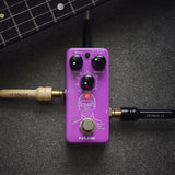 NU-X NDD-3 Edge Mini Delay Pedal in purple with Mix, Repeat and Time knobs, red mode button and footswitch, shown with guitar neck and jack leads.