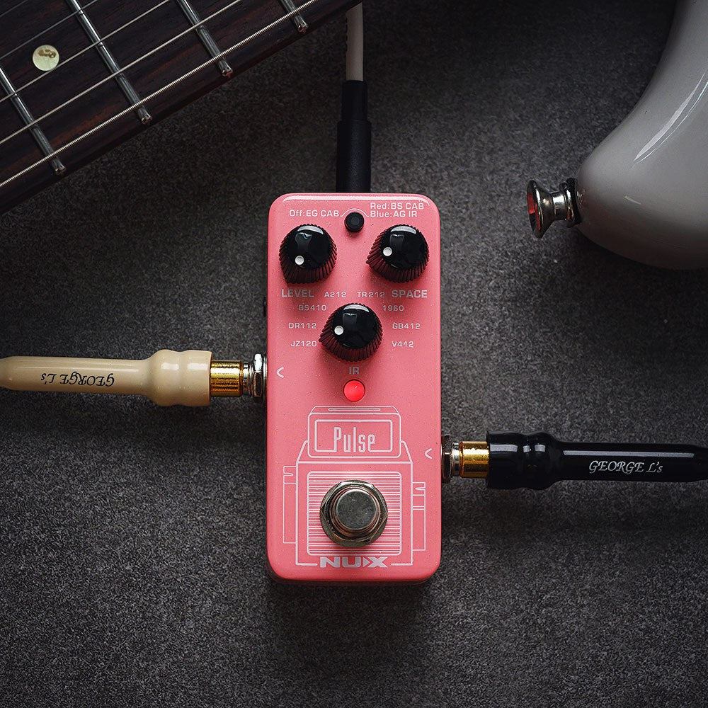 NU-X NSS-4 Pulse IR Loader guitar pedal in pink with Level, Space and IR mode knobs, footswitch, shown beside a guitar neck and cables.