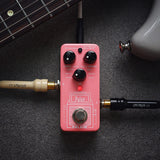 NU-X NSS-4 Pulse IR Loader guitar pedal in pink with Level, Space and IR mode knobs, footswitch, shown beside a guitar neck and cables.