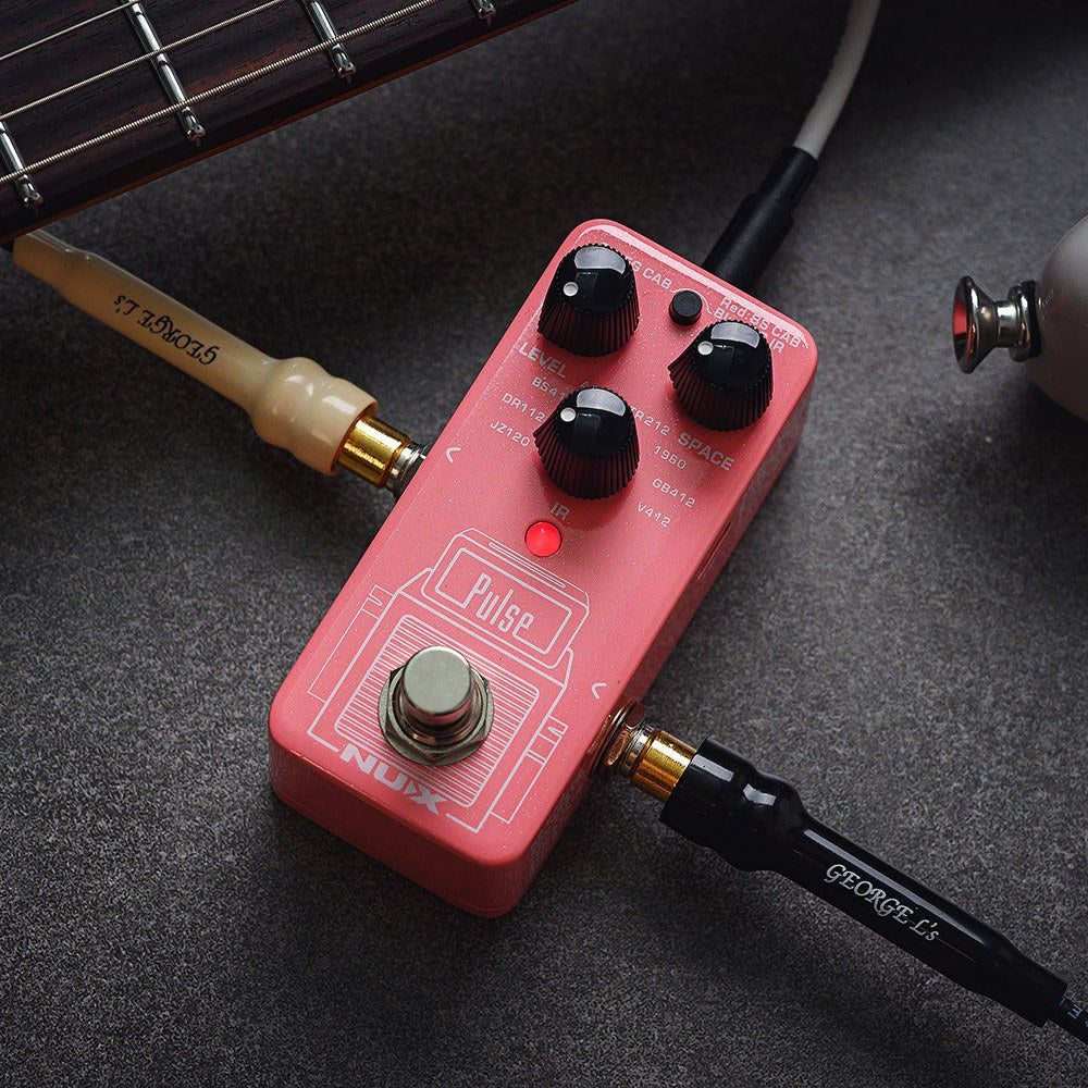 NU-X NSS-4 Pulse IR Loader guitar pedal in pink with Level and Space knobs, red LED and footswitch, connected via cables beside a guitar neck.