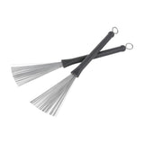 Chord WBRUSH retractable wire drum brushes shown as a crossed pair with matt black plastic handles and fanned steel wire bristles on a white background.