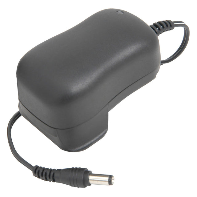 The Chord Guitar Pedal PSU - UK Plug is a black power adaptor featuring a curved, rectangular body and a cable that ends in a cylindrical plug. Ideal for guitar effects, its coiled cable is designed with energy efficiency in mind.