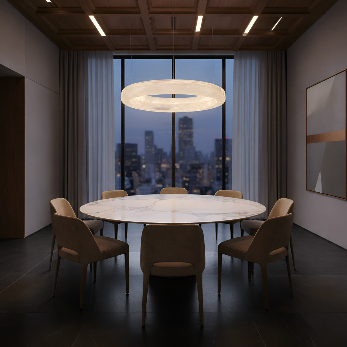 A modern dining room with a round marble table, eight beige chairs, the Aurexis LED Large Floating Ring Alabaster Suspension Light in soft white above, floor-to-ceiling windows with city views at dusk, and abstract art on the wall.