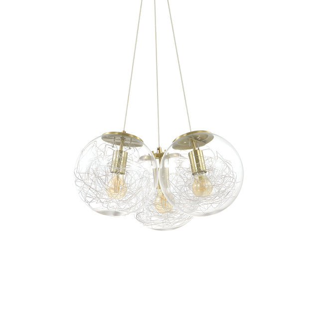 The Lyria 3 Light Cluster Pendant - Brass showcases a contemporary design with three clear blown glass diffusers. Each globe is adorned with a decorative wire pattern encircling a vintage-style filament bulb, elegantly suspended from a central brass mount by three cables.