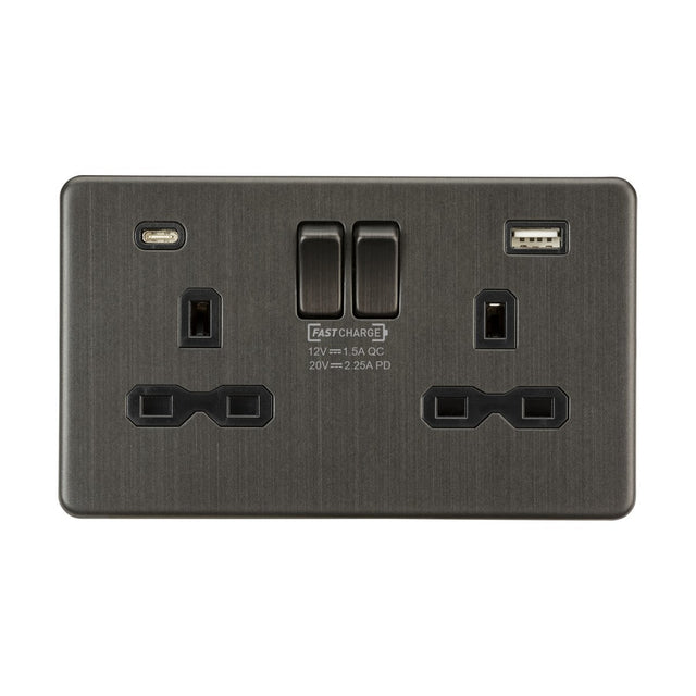 The 13A 2 Gang DP Switched Socket in Smoked Bronze includes two UK outlets, a high-power USB-C, dual USB ports, and switches. It features text highlighting fast charging capabilities and comes with a black insert and screwless design.