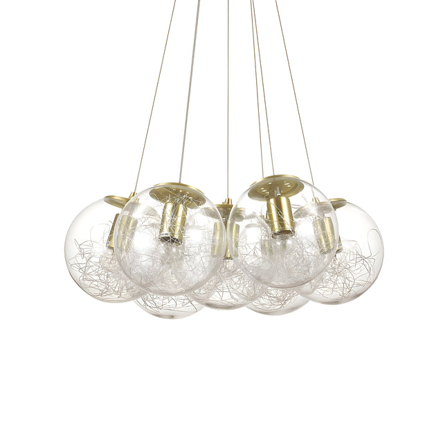 The Lyria 7 Light Cluster Pendant - Brass features a contemporary style with its seven glass spheres. Inside each sphere is a nest of silver wires, all elegantly suspended by delicate wires and highlighted by a brass finish, bringing sophistication to any room.
