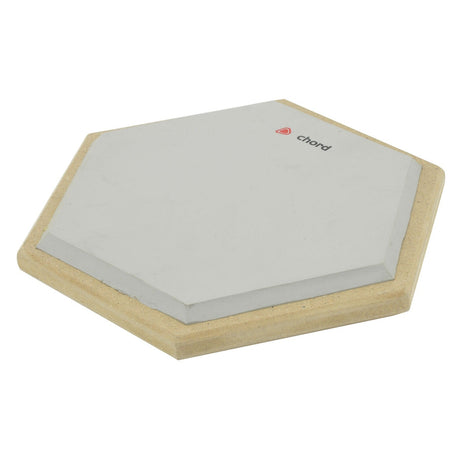 The Chord Hexagon Drum Practice Pad boasts a high-density rubber playing surface and a wooden base, complete with a small "Chord" logo in the corner. Designed for durability, it also features a protective foam base to provide stability during intense practice sessions.