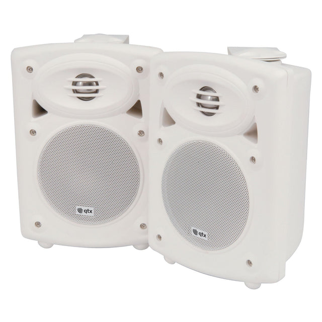 A pair of QTX QR5W 5" 20W Active ABS Speakers in white, featuring a compact, rectangular design. Each speaker includes a circular grille adorned with a small brand logo. Built-in amplifiers ensure these speakers provide deep bass response, and when positioned side by side against a white background, they easily blend into any setting.