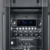 Close-up of the QTX QR10PA portable PA speaker control panel showing AUX IN display, USB port, SD slot, mode buttons and EQ knobs.