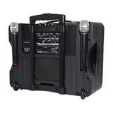 Rear view of the QTX DELTA-200 portable PA system by AVSL with two wireless handheld microphones in side holsters, control panel, wheels, and trolley handle.