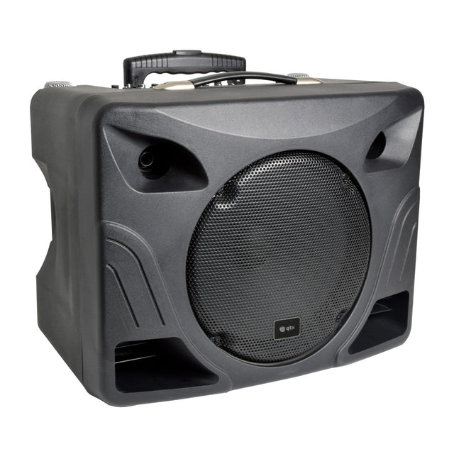 The QTX DELTA-200 Performance Portable PA Unit is a black portable PA system featuring a prominent front-facing grill, two lower slotted vents, and a convenient top handle. Its angular design is accentuated by gentle curves and discreet branding near the center of the grill. Additionally, it includes a Bluetooth receiver for seamless connectivity.