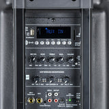 Rear control panel of the QTX QR15PA portable PA speaker showing AUX IN display, USB, SD slot, EQ knobs, UHF mic controls, and input jacks.