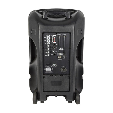 QTX Busker-15 portable PA speaker rear view showing control panel with VHF antennas, jack and RCA inputs, dials, mains input and wheels, on a white background.