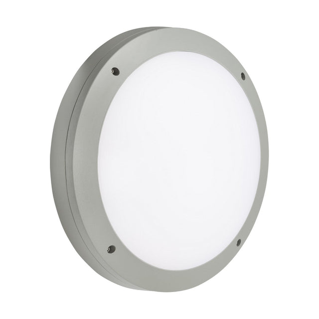 The 18W Outdoor CCT LED Bulkhead - Grey is a round light fixture featuring a white frosted diffuser, a gray metallic rim, and visible screws for wall-mounting. It boasts a simple and modern design, is IP65-rated for outdoor use, and includes CCT adjustable settings to fit any ambiance.