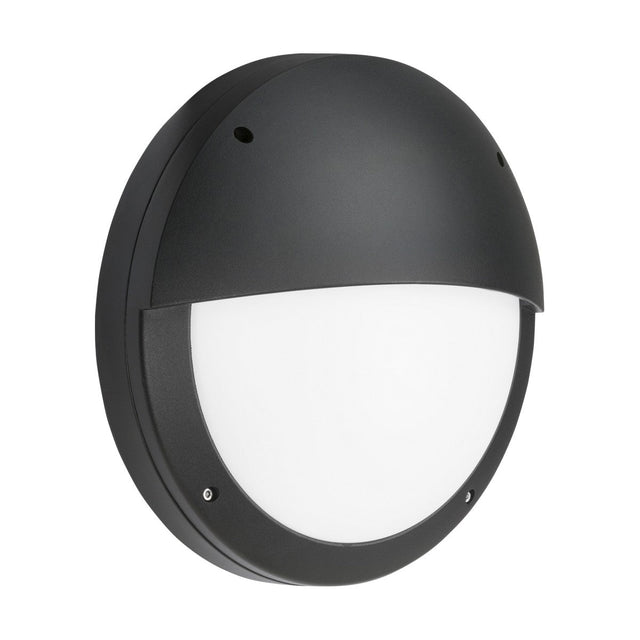 The 18W Outdoor CCT LED Eyelid Bulkhead With Microwave Sensor in black, designed for exterior walls, is crafted from die-cast aluminium and features a half-covered white diffuser. This IP65-rated fixture combines durability and style with its sleek, modern appearance and two small screws visible on the lower half for mounting.