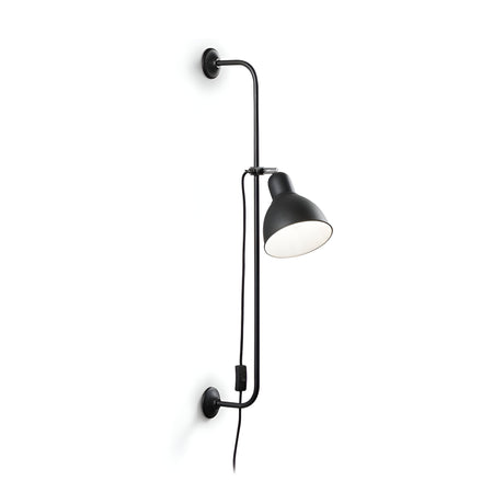 The Etera Wall Light - Black is a sleek wall light made of metal, featuring a curved arm and an adjustable shade with a visible power cord and switch. This contemporary lighting piece is elegantly set against a plain white background.