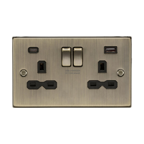 The 13A 2 Gang SP Switched Socket with Dual USB in antique brass combines elegance and functionality, featuring two plug outlets, a USB-A port, a USB-C port, and two rocker switches for efficient power control.