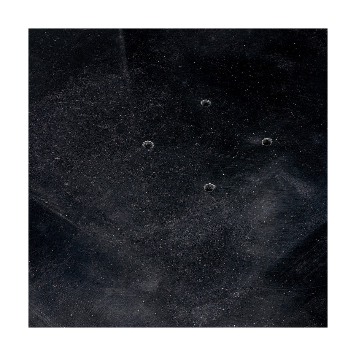 Modena polished black granite parasol base, close-up of the dark surface with four visible pole mounting holes arranged in a square pattern.