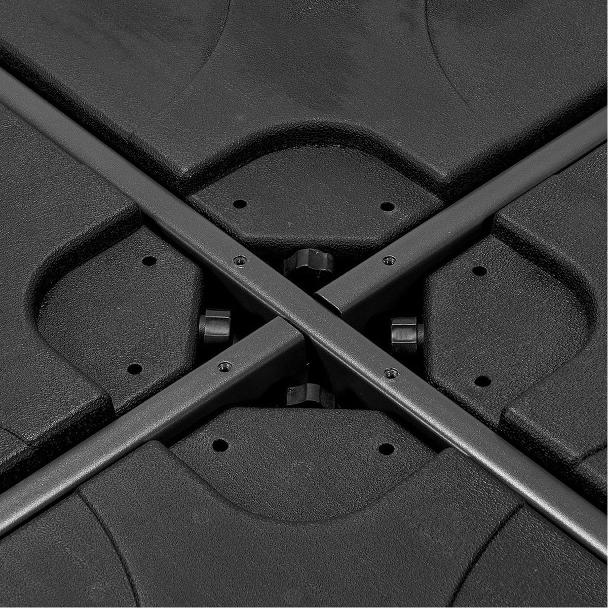 Close-up of the Steel Parasol Cross Base in matte black, showing the crossed steel poles and moulded base sections joined with visible screws.