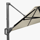 Close-up of the Voyager T1 X cantilever parasol in champagne, showing the dark grey aluminium pole, angled support arm, and canopy ribs against a plain background.