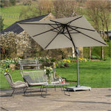 Voyager T1 X rectangular cantilever parasol in champagne with black side arm and weighted stone base, shading a rattan seating set and table on a garden patio.