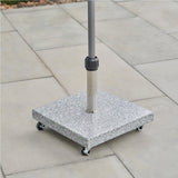 Salerno Hammered Grey wheeled parasol base in square granite-effect stone with castor wheels, supporting a stainless steel and grey pole on an outdoor patio.