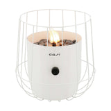 Cosi Basket White Gas Flame Lantern, 31cm, with a wire-cage steel design around a white ceramic burner filled with pebbles and a lit flame, control knob on front, shown on a plain white background.