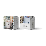 Cosi Basket White Gas Flame Lantern, 31cm, shown in retail packaging with two boxes displaying product images and specifications on a plain white background.