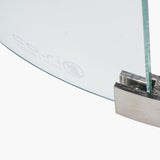 Close-up of the Cosiglass 52cm fire pit glass surround edge secured in a brushed chrome metal bracket, tempered glass panel on a white background.