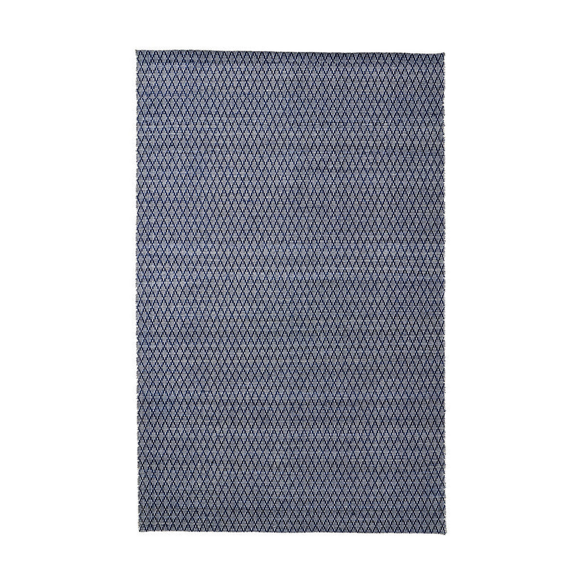 Rectangular indoor outdoor rug in denim blue and white with a small-scale diamond ikat pattern, shown flat against a plain white background.