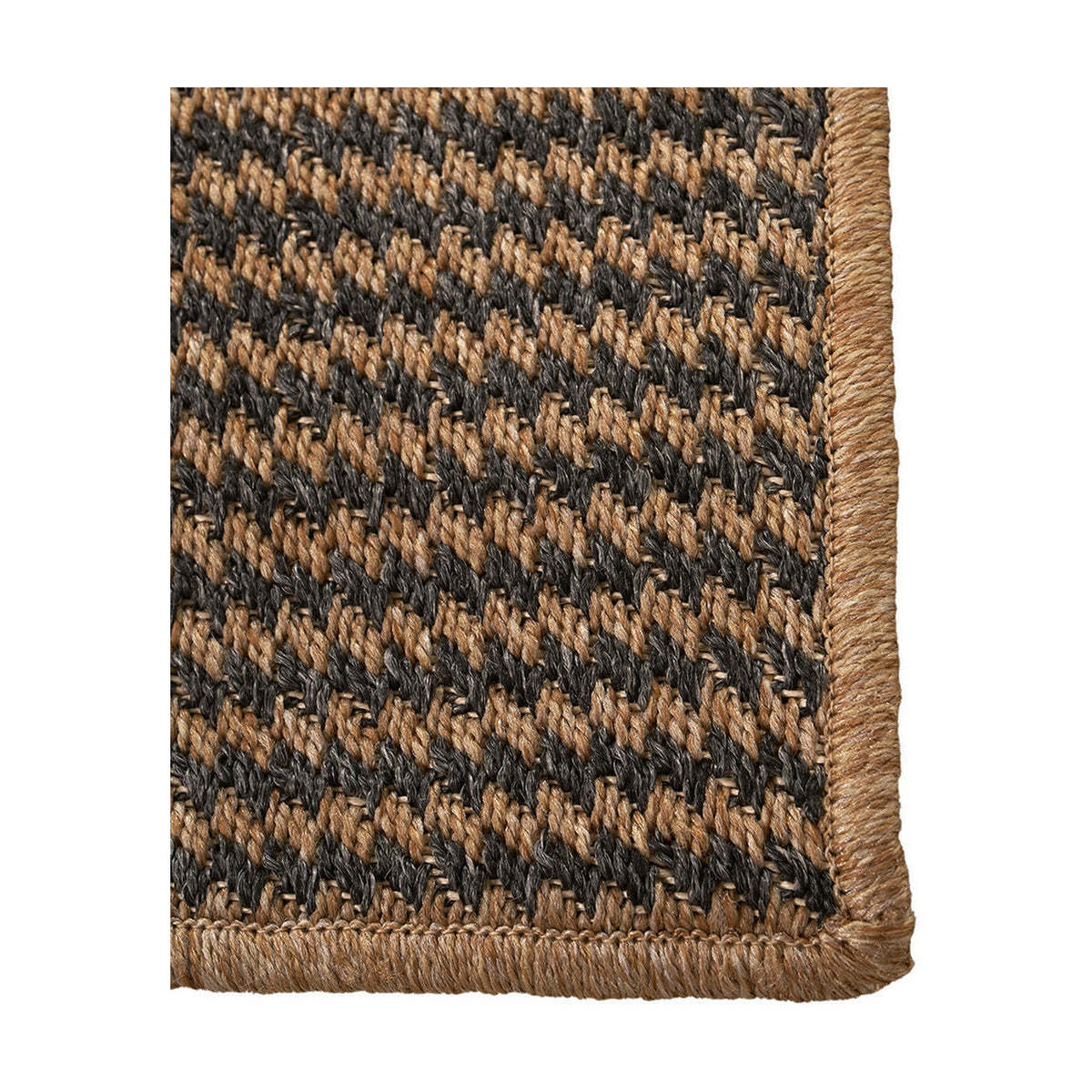Corner detail of the Indoor Outdoor Natural & Slate Grey Design Rug, showing a woven houndstooth pattern with a natural whipstitch edge binding.