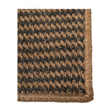Corner detail of the Indoor Outdoor Natural & Slate Grey Design Rug, showing a woven houndstooth pattern with a natural whipstitch edge binding.