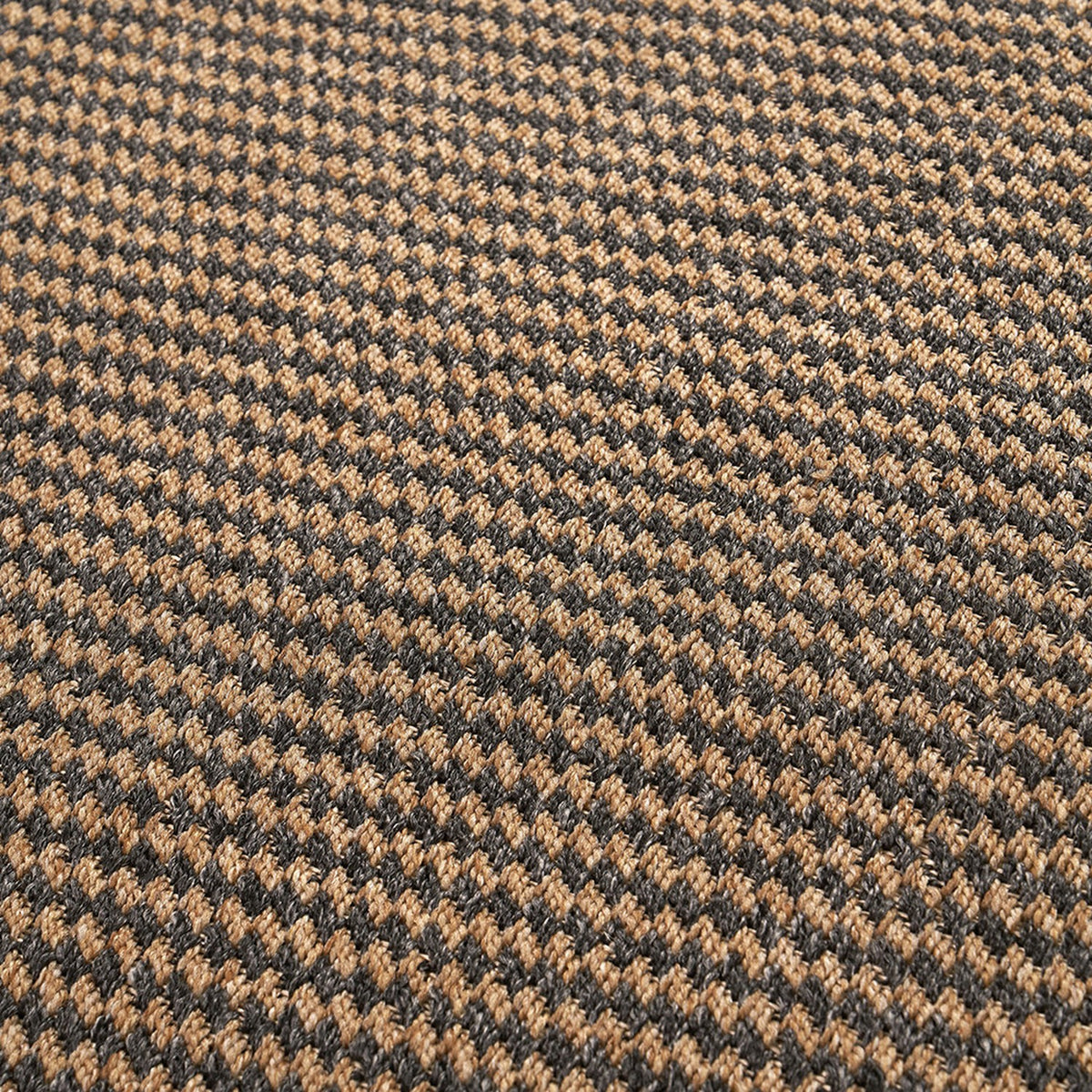 Close-up of an indoor outdoor rug in a woven houndstooth pattern, natural tan and slate grey polypropylene fibre, 230 x 160cm.