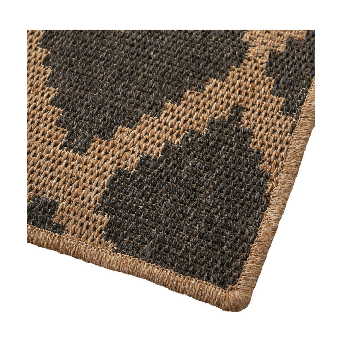 Corner detail of the Indoor Outdoor Natural & Slate Grey Diamond Design Rug, showing a flat-woven polypropylene diamond pattern with a natural woven edge binding.