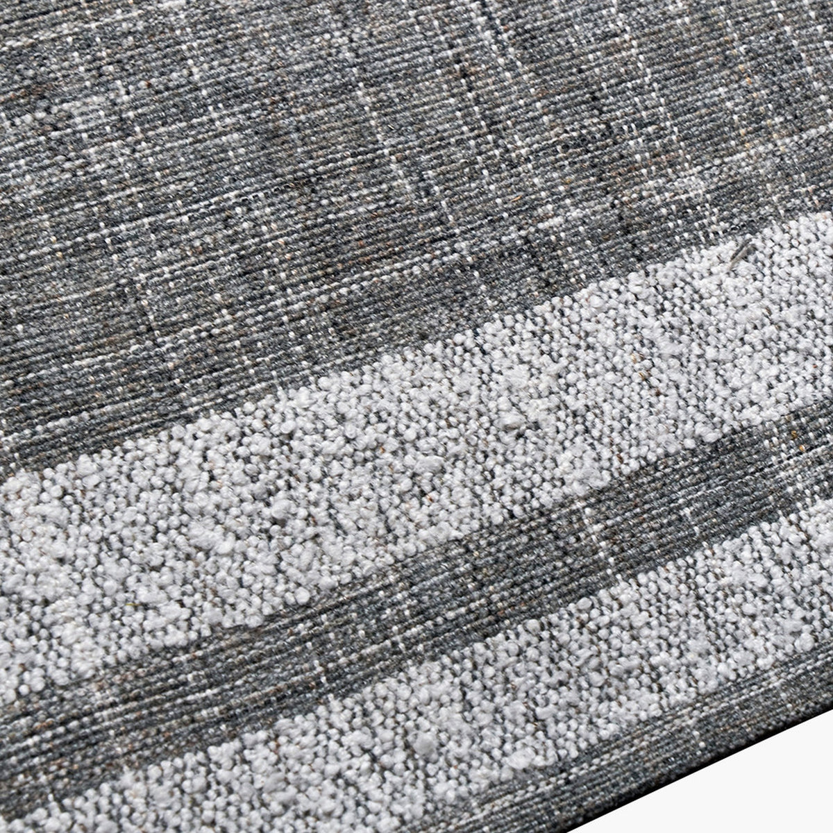 Close-up of the Indoor Outdoor Steel Grey & White Stripe Design Rug, 230 x 160cm, showing a woven grey polyester texture with a horizontal white striped band.