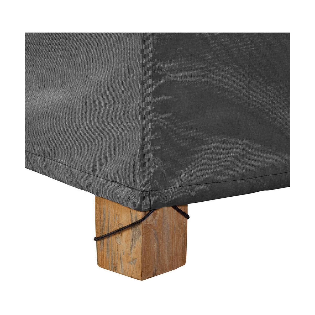Close-up of the Firetable Aerocover, 112 x 82cm, in anthracite polyester fabric, showing a corner seam secured with a cord toggle around a wooden furniture leg.