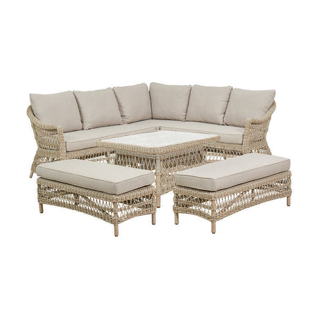 Pattaya Outdoor Corner Seating Set with beige cushions, woven aluminium corner sofa, two matching benches and a rectangular coffee table, on a plain white background.