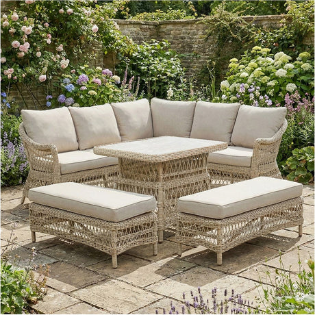 Pattaya Outdoor Corner Seating Set in sand-coloured synthetic weave with beige cushions, featuring a corner sofa, rectangular table, and two benches on a garden patio.