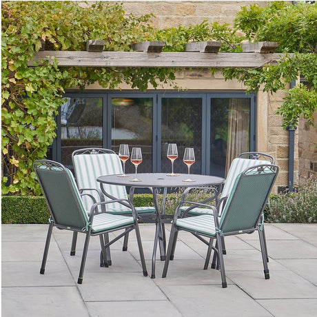 Savoy Round 4 Seater Dining Set with sage green striped cushions on stackable dark metal chairs, paired with a round glass-top table on a patio.